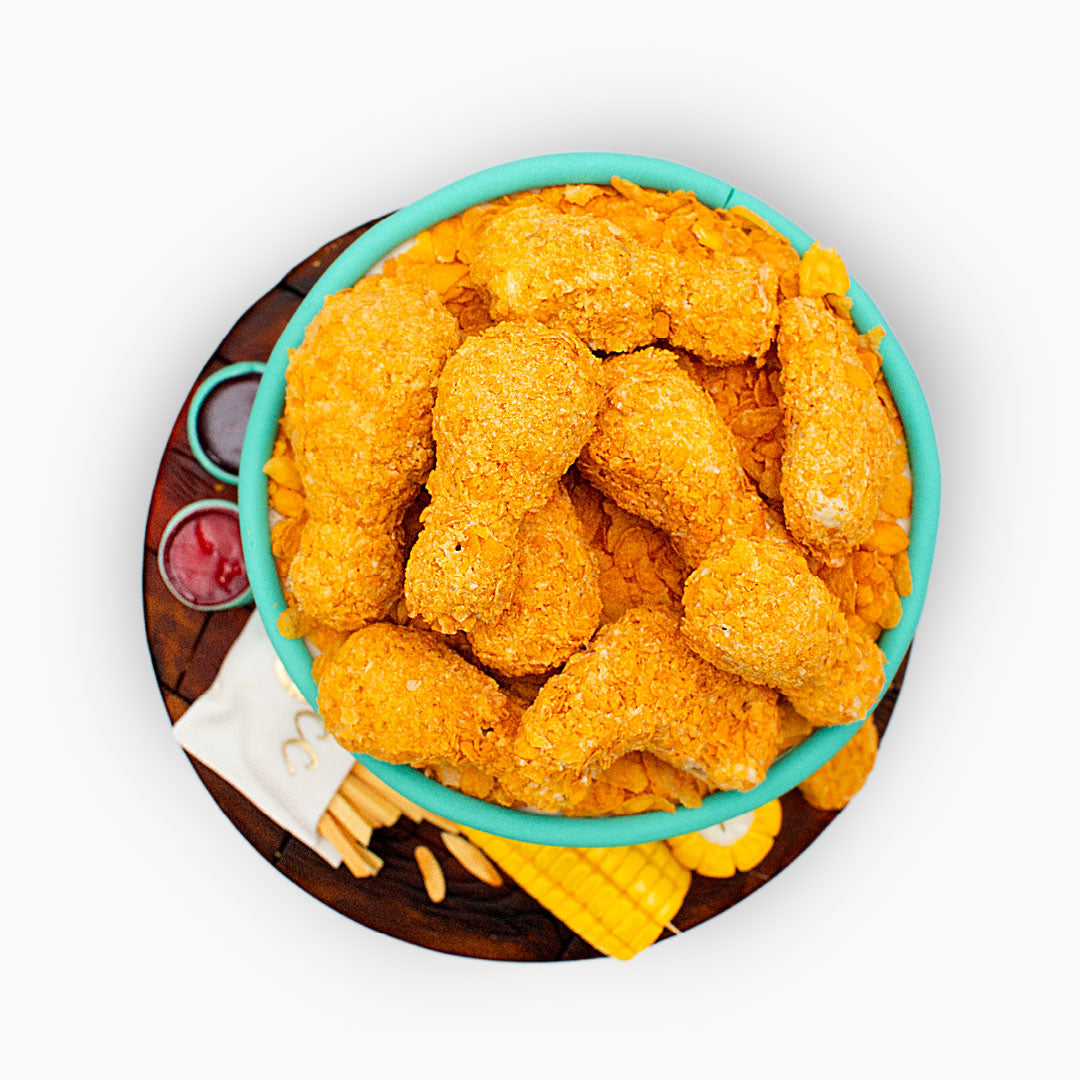 Fried chicken-themed birthday cake featuring a bucket filled with edible chicken pieces, fries, corn on the cob and dipping sauces