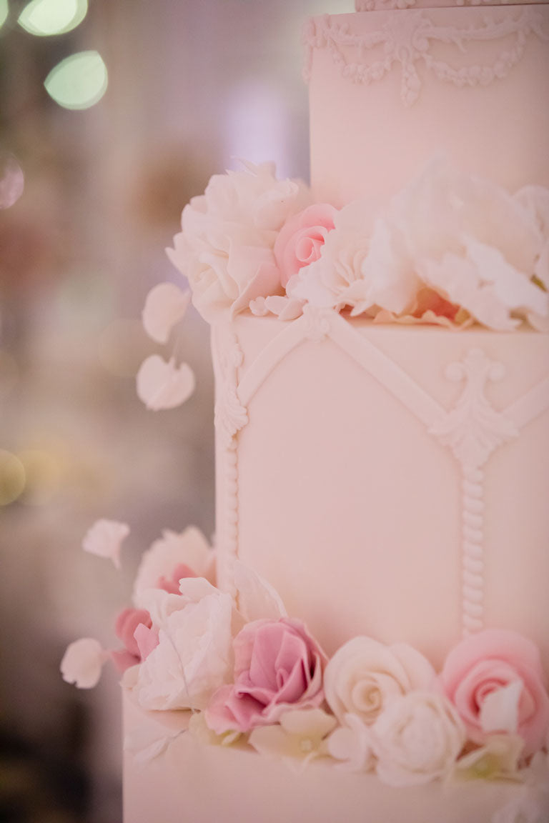 white and pink roses made of icing on a pink wedding cake at the savoy
