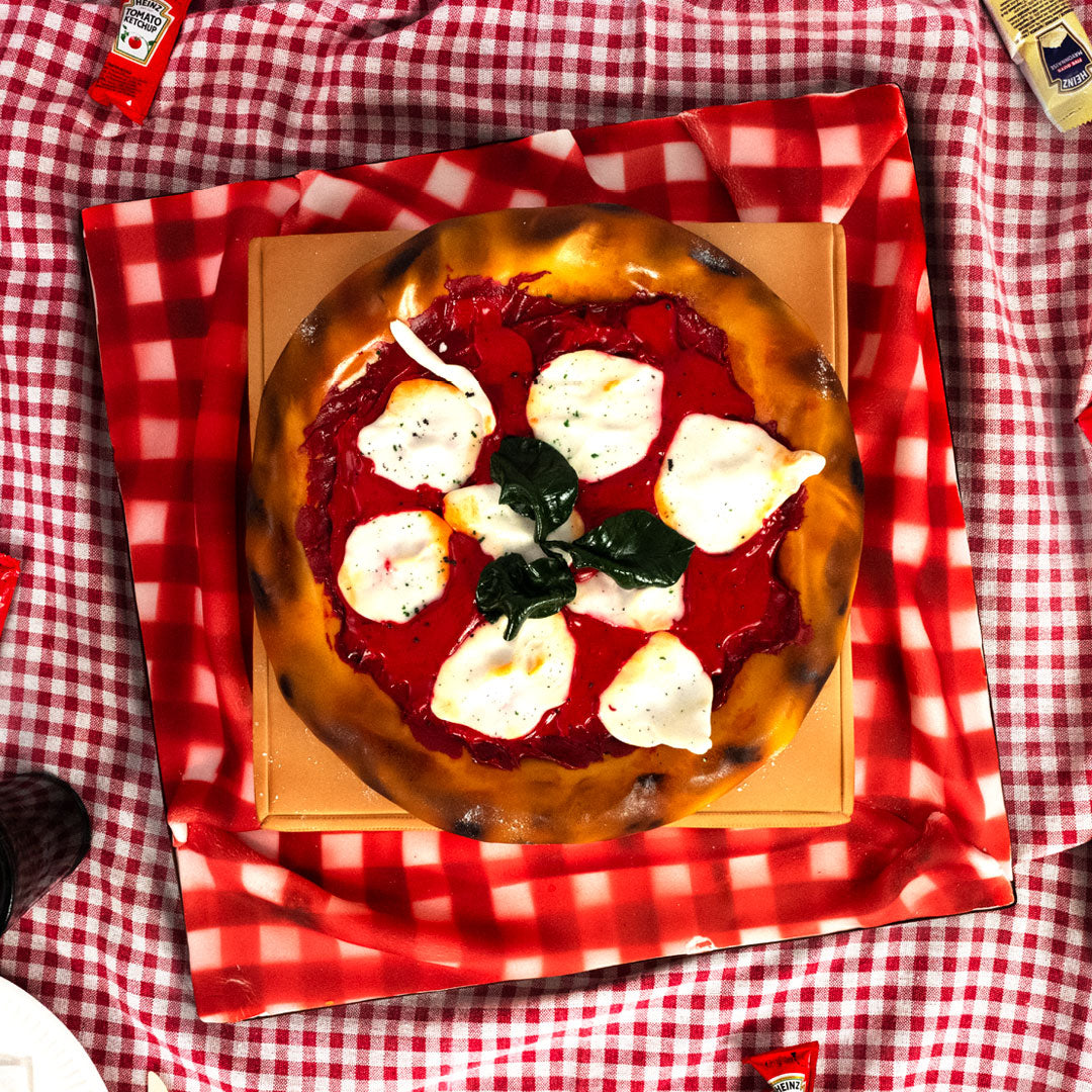 A pizza cake no other. Delicious golden crust with edible cheese and mozzarella toppings, even the pizza box is cake