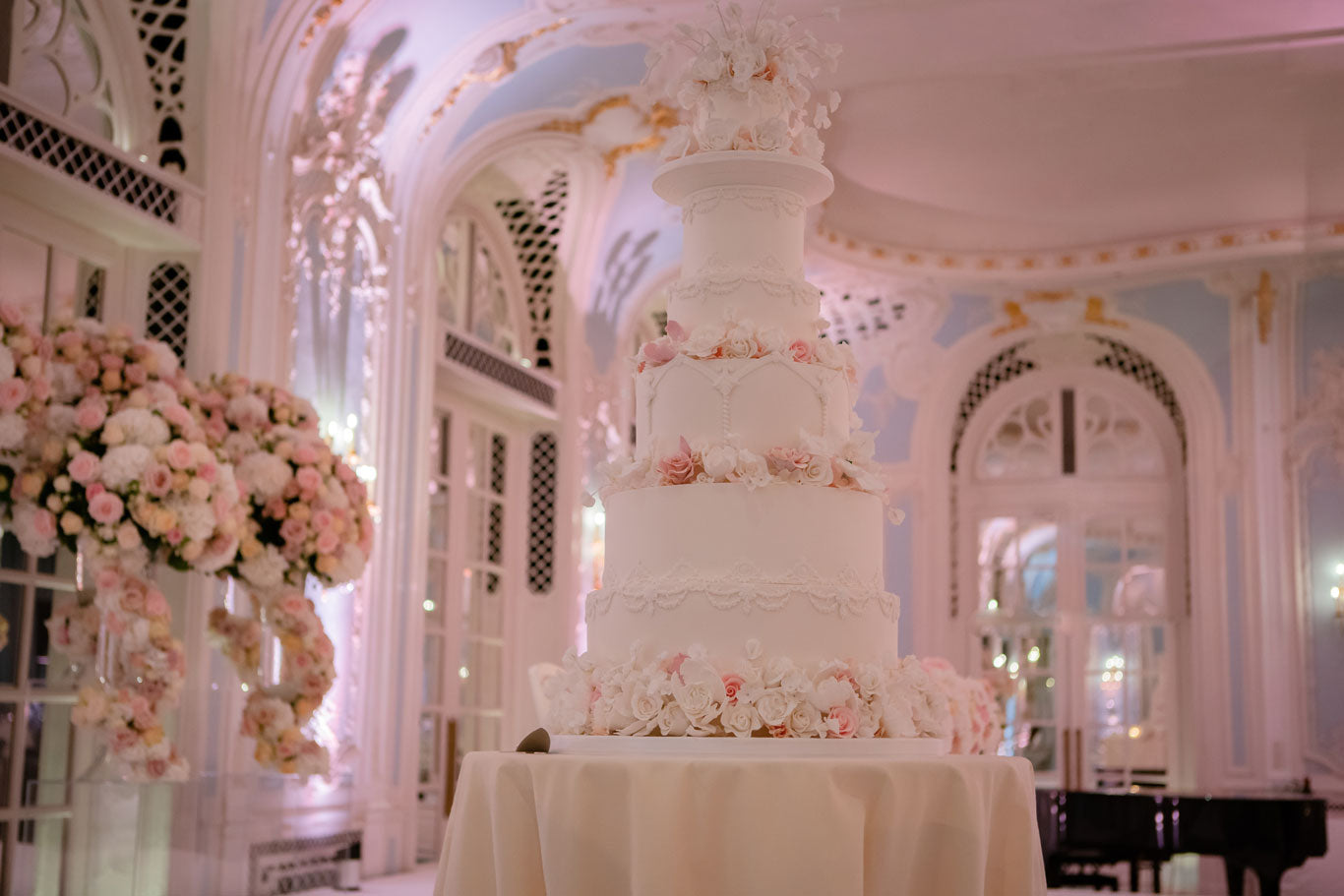 luxury wedding cake set on a table in a grand room at the savoy hotel