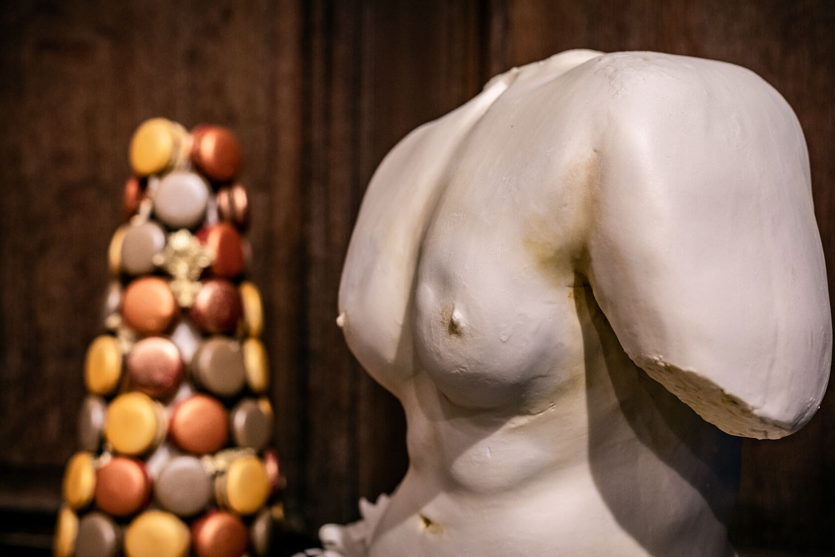 cake statue of a torso at a private london event in an high end book store
