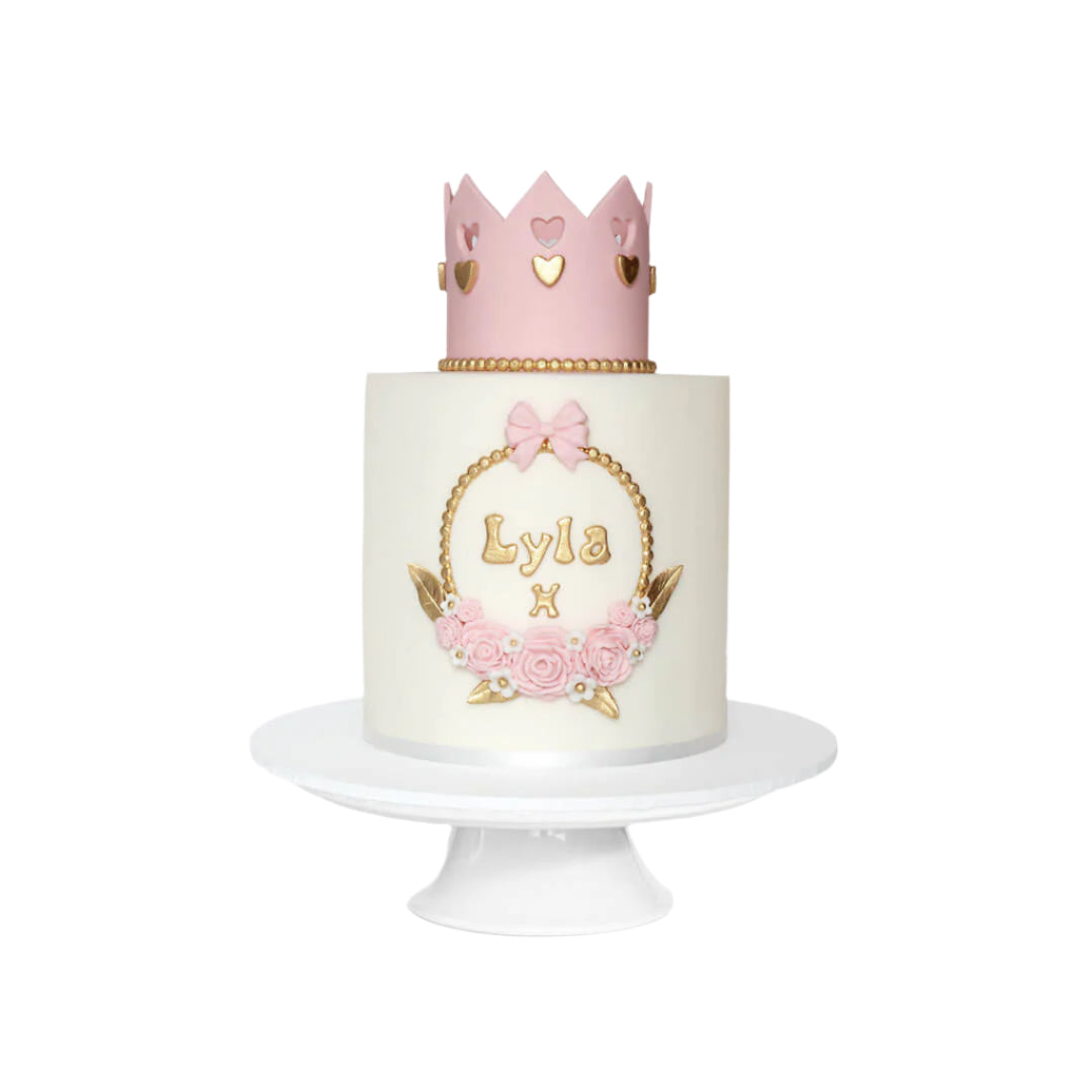 Children's birthday cake with white fondant icing a cute pink & gold princess crown on tope, personalised with name at the front