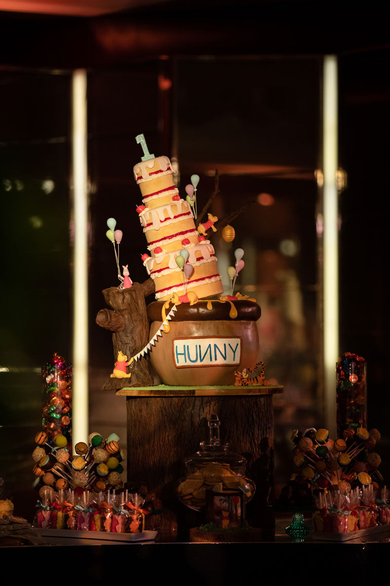 giant winnie the pooh cake designed to look like it is falling over