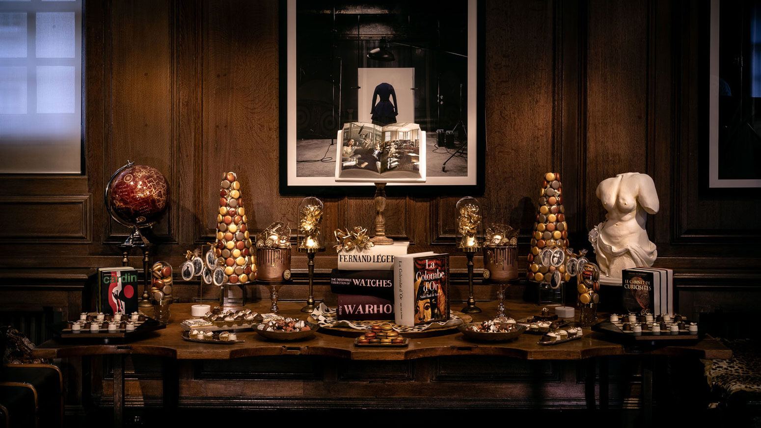  a table of desserts in unique shapes at an event in maison assouline