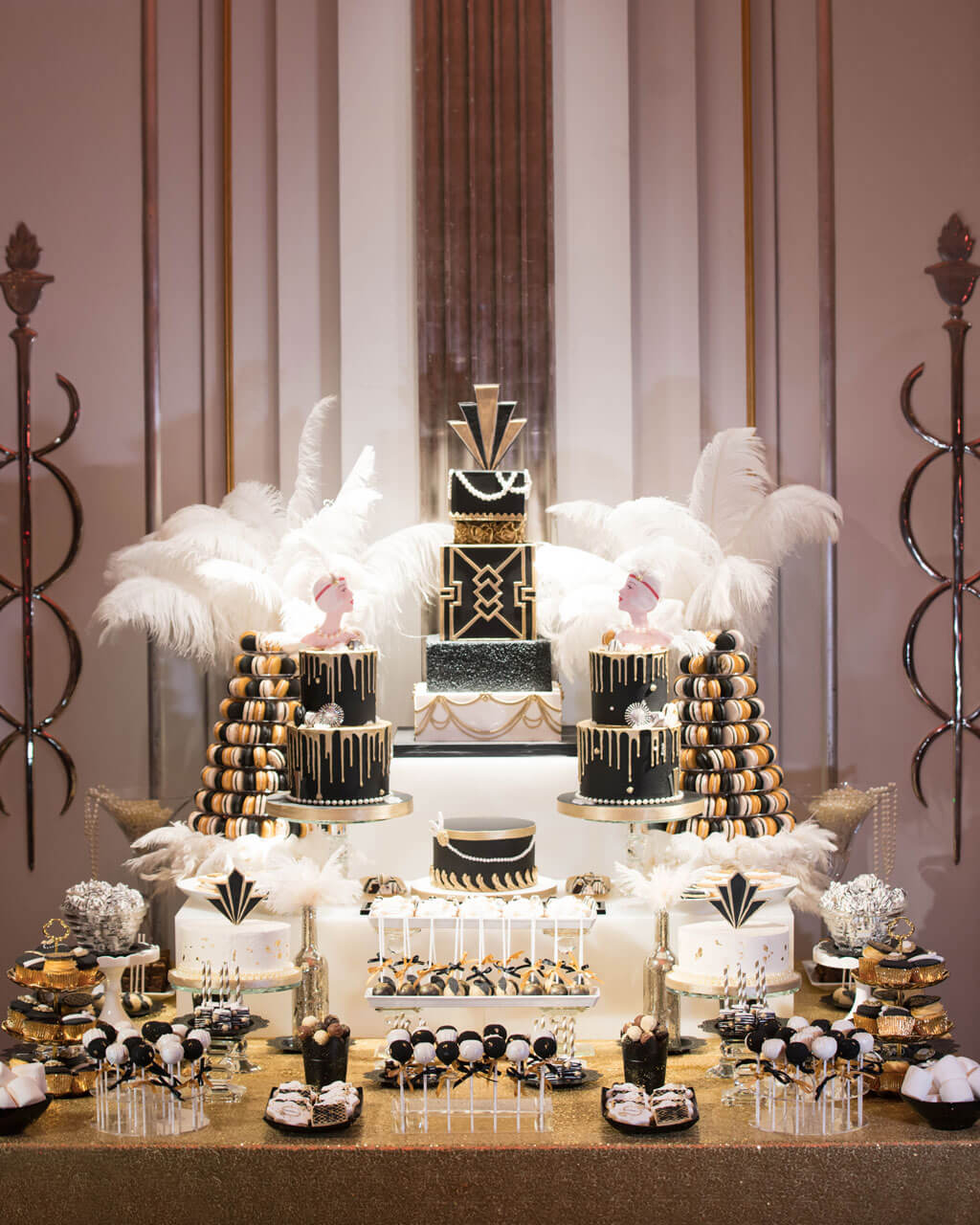 great gatsby art deco cake dessert table in black and gold in claridges