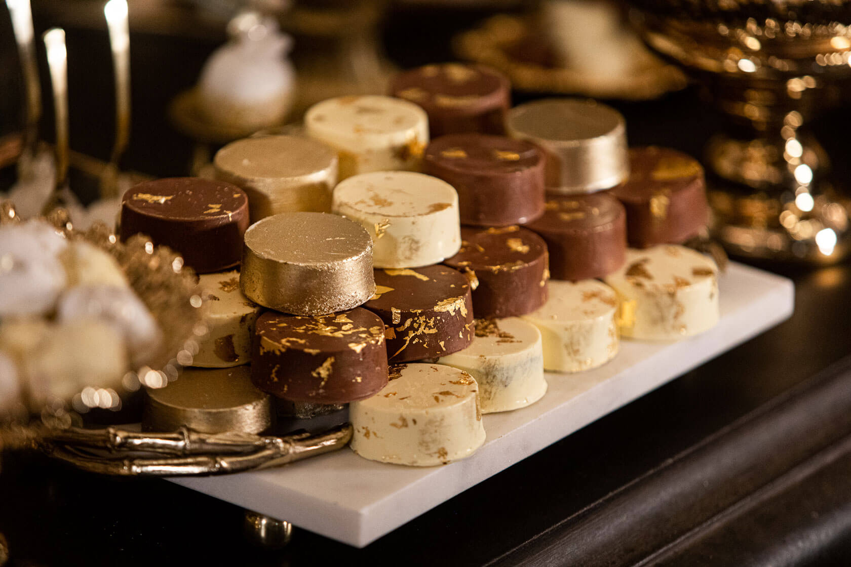 luxury milk white and gold chocolate covered cookies at a bespoke desert station