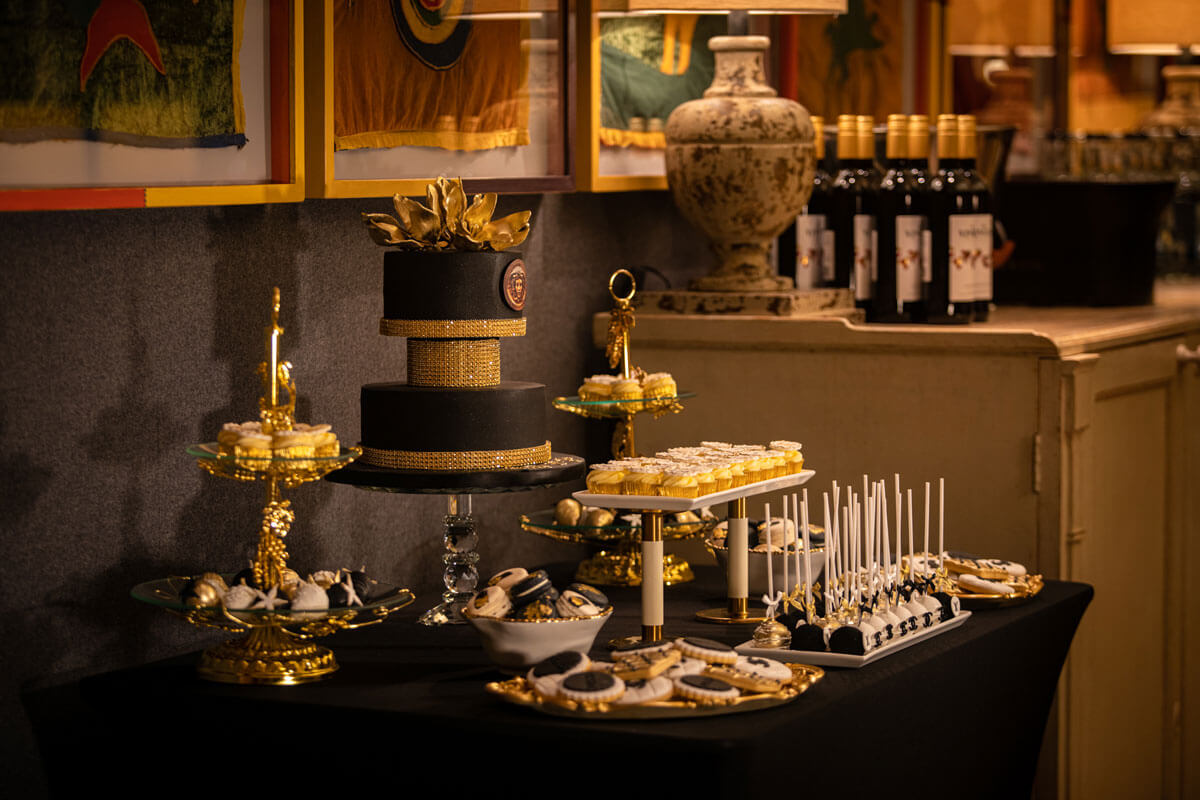 private party luxury bespoke dessert table in black gold and white