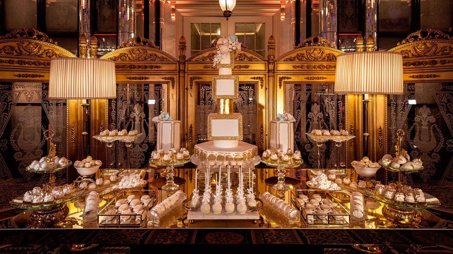 elegant white and gold dessert display with seven tiered wedding cake centrepiece