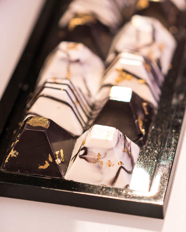 black white and gold marble chocolates in a pyramid shape