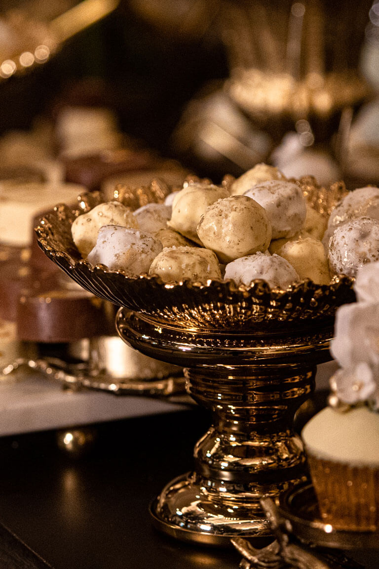 sweet treats in a gold bowl at a desert station in the palm court at the kimpton fitzroy hotel london