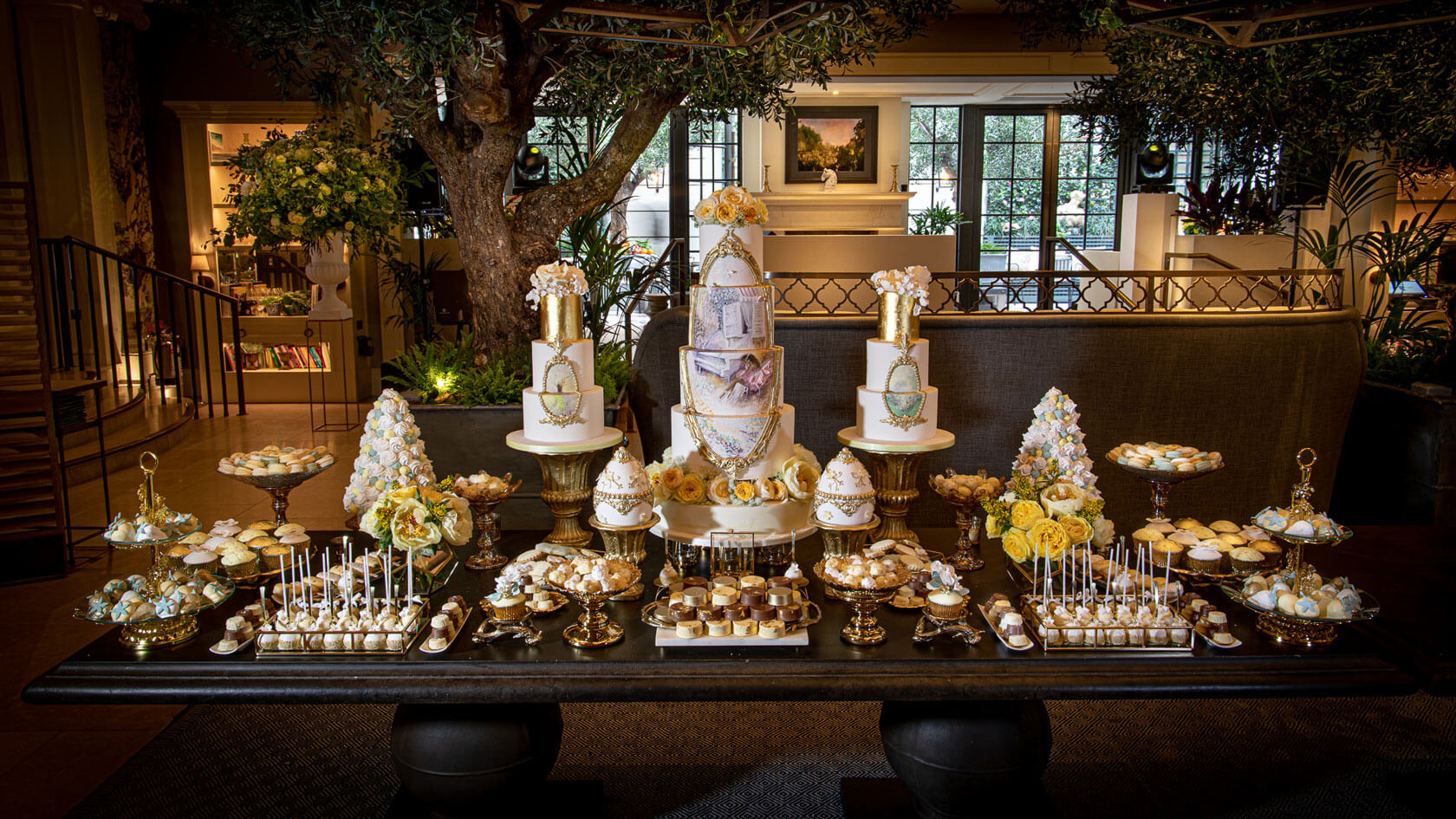 a luxury display of indulgent sweet deserts on a table at the kimpton fitzroy hotel