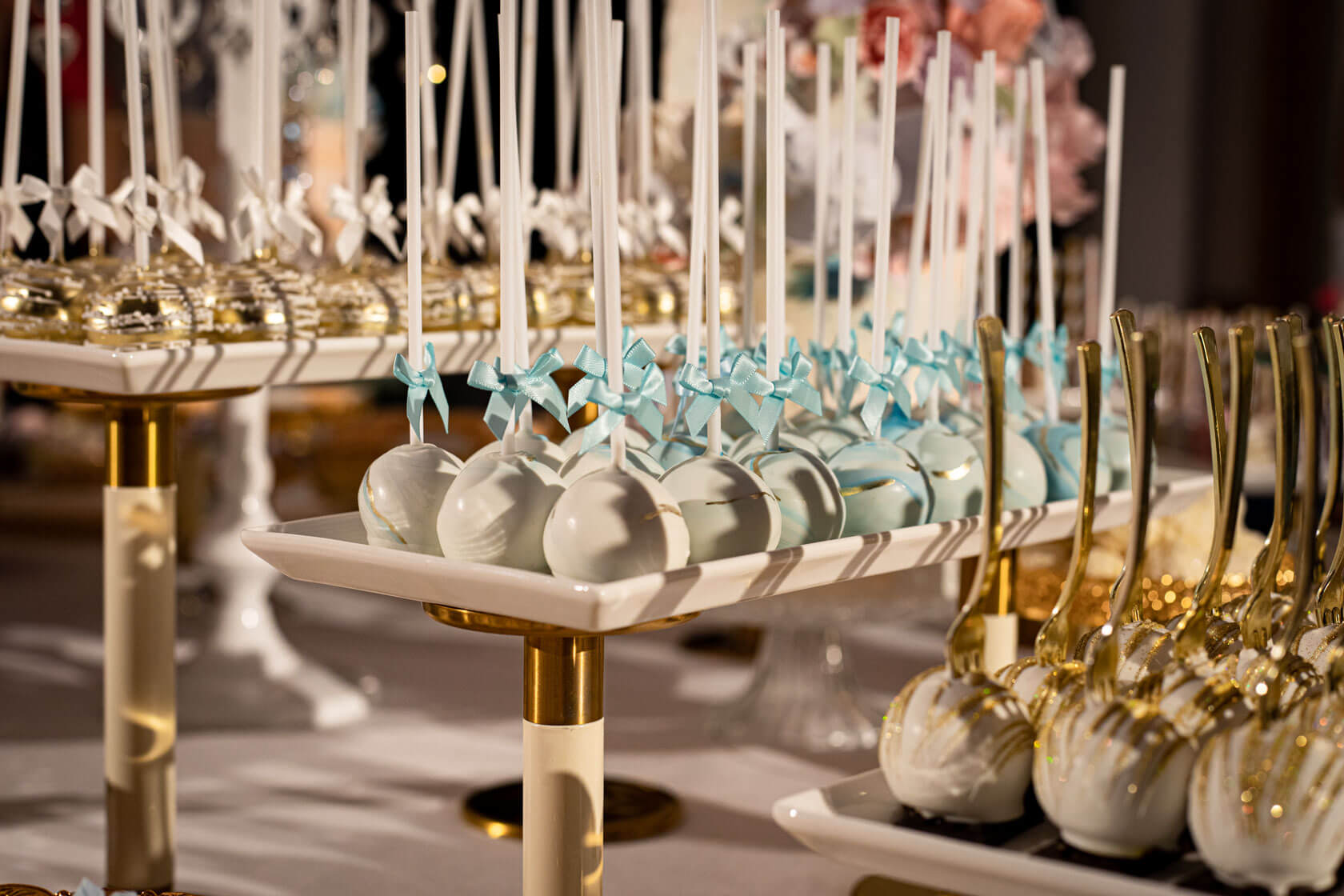 rows of luxury bespoke cake pops on display trays