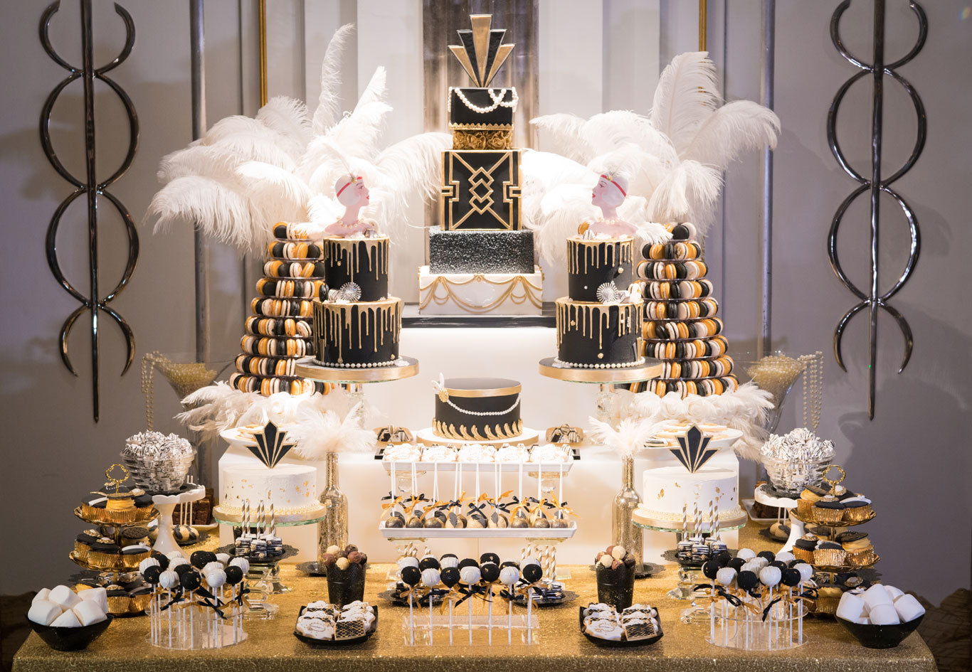 black white and gold gatsby dessert station full of tiered cakes and sweet treats