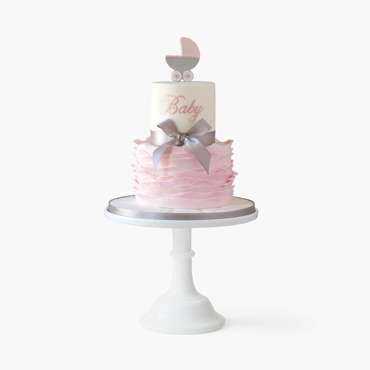 Two tier baby shower cake with delicate pushchair topper and fondant ruffles base and personalised name