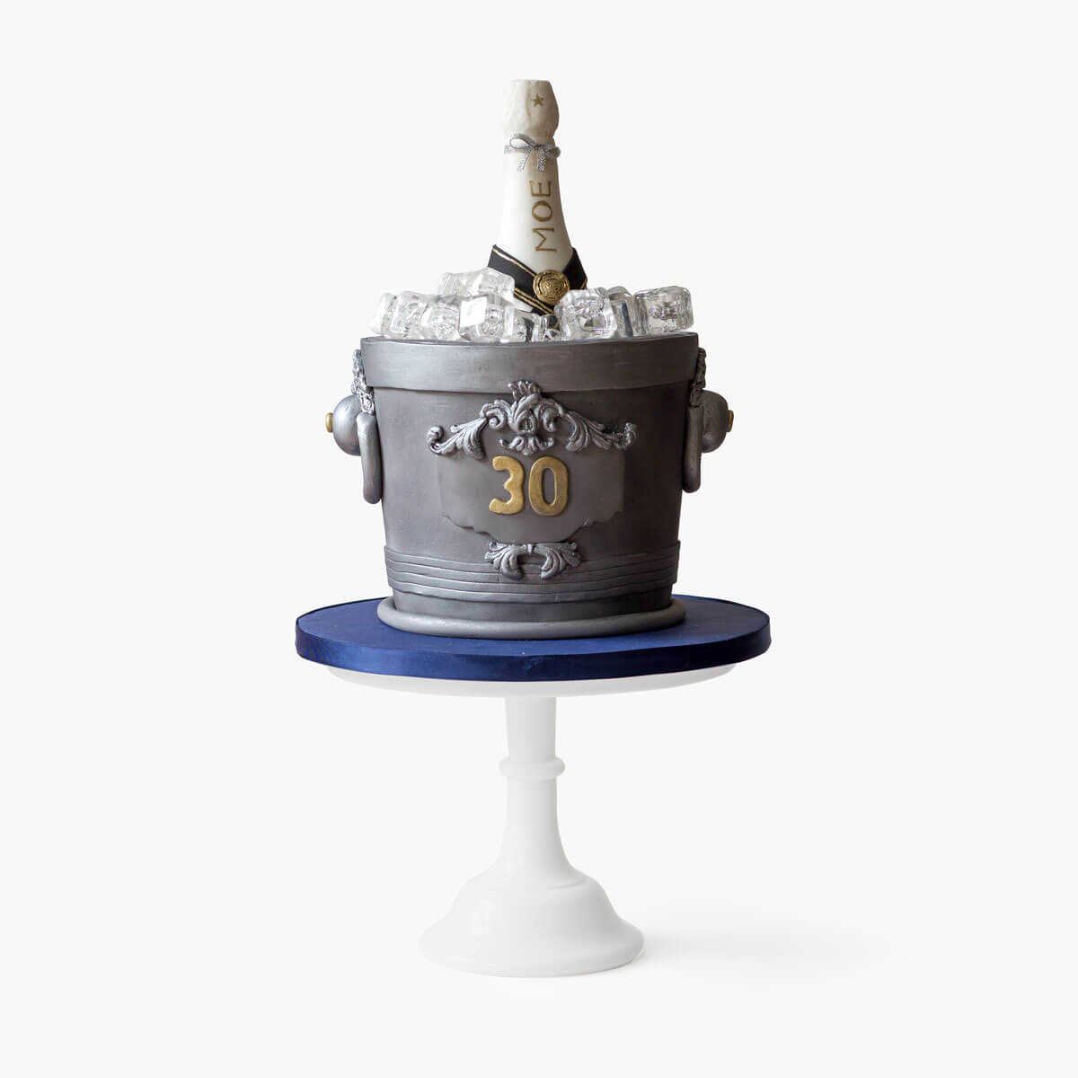 Custom-desiged champagne bucket cake with a non edible champagne bottle, realistic ice cubes and a metalic silver finish