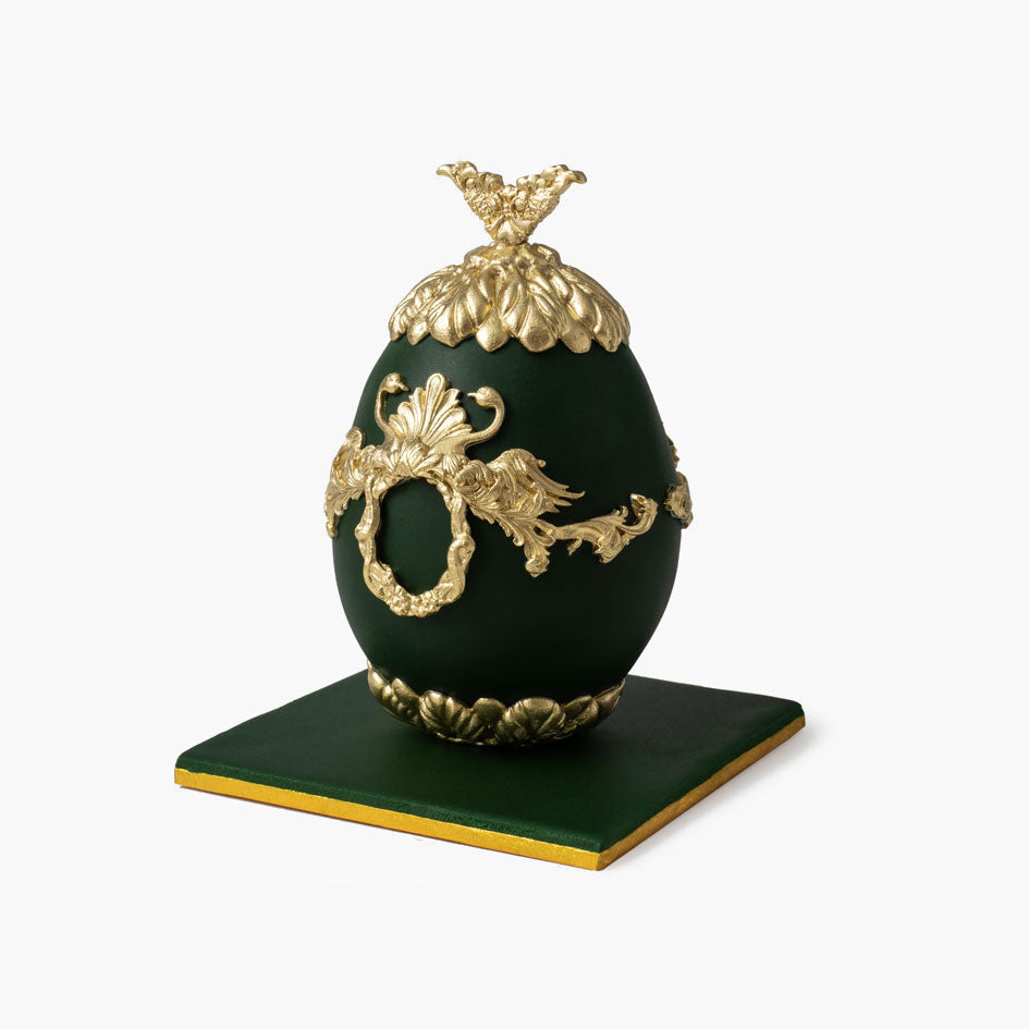 Green Faberge cake egg with ornate gold decorations and crown