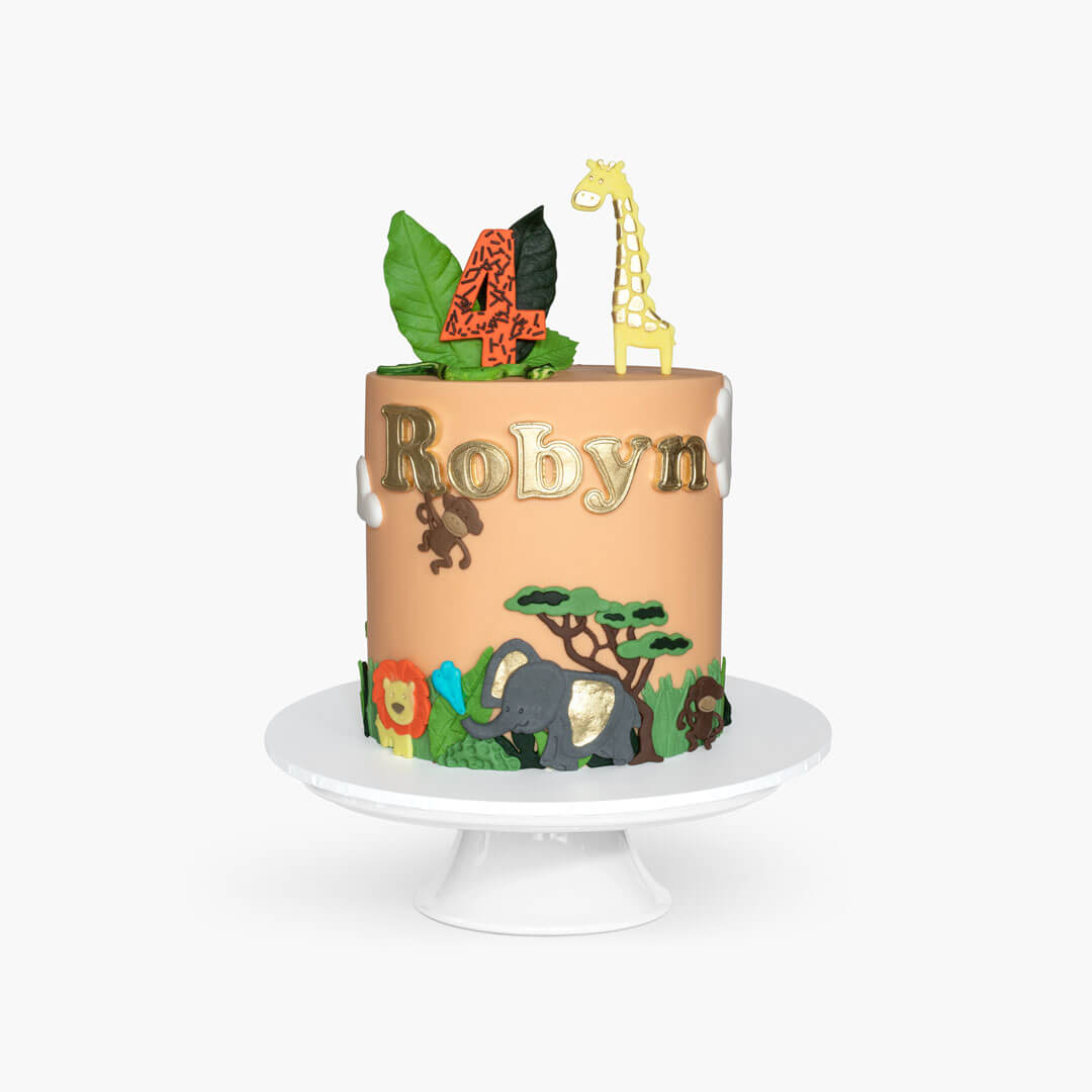 Fun childrens animal birthday cake featuring a colourful safari scene with jungle animals, personalised with age and name handpainted in gold