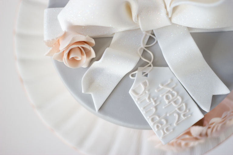 Luxury blush pink and grey bow cake with edible fondant personalised gift tag and handmade roses